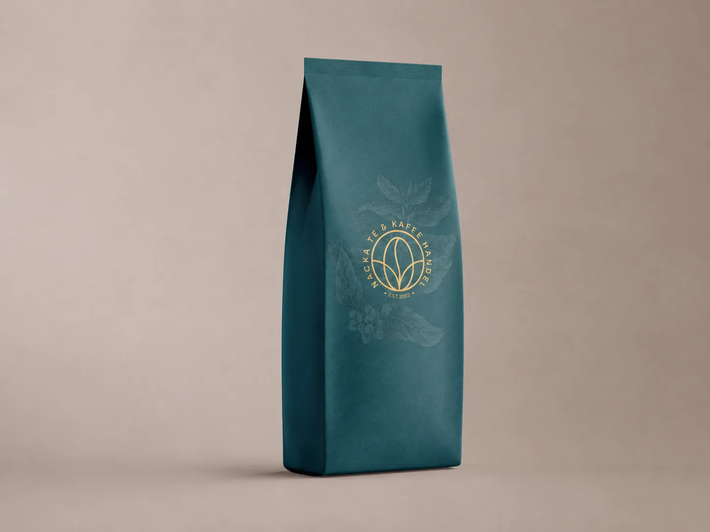 Petrol coffee pouch with the gold badge and tonal botanical illustration