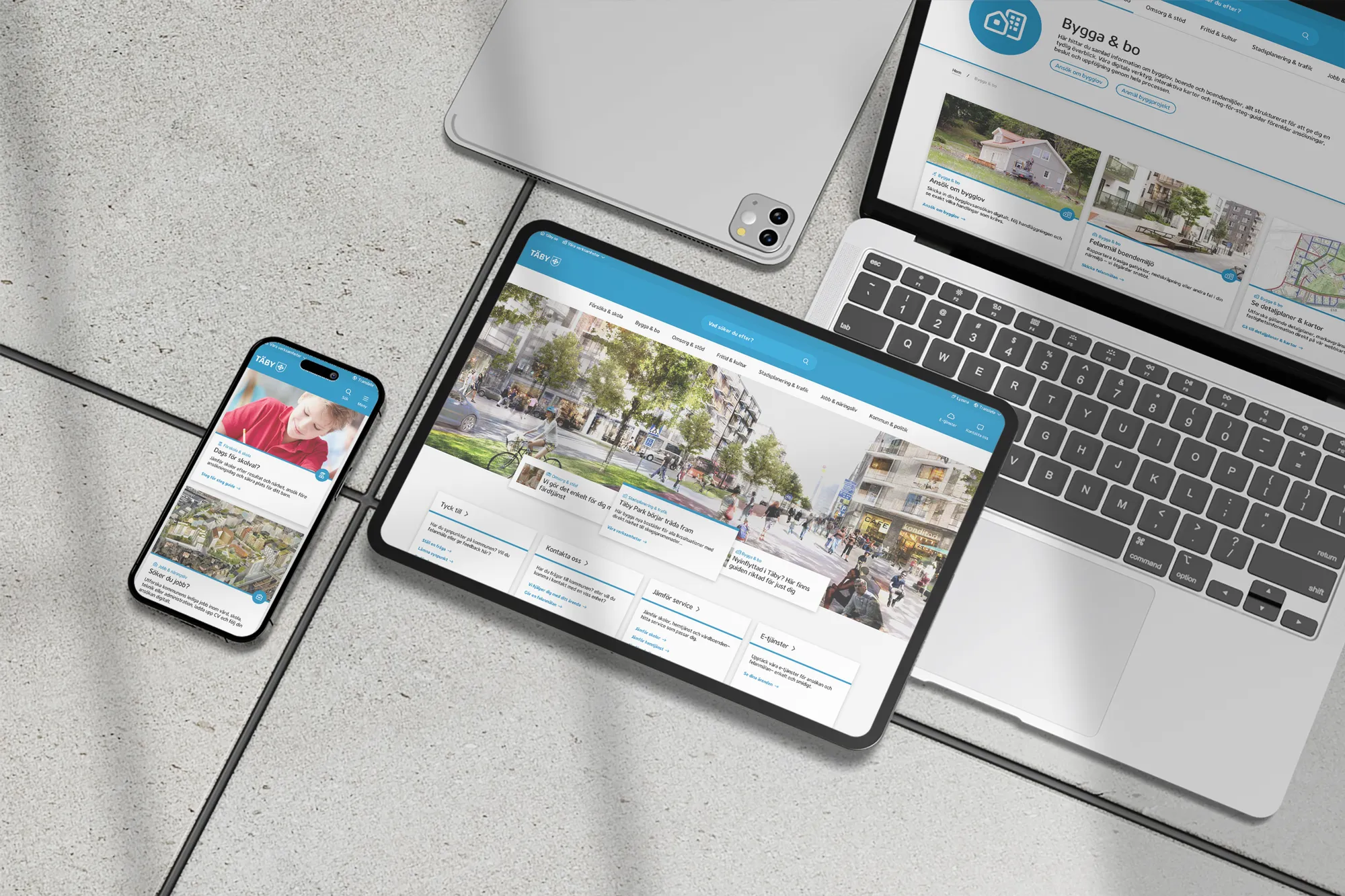 The Täby site across a phone, a tablet and a laptop, showing the home page, news and the Bygga och bo section